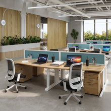 Load image into Gallery viewer, Connection under desk drawers shown in modern open plan office with bench desk setups
